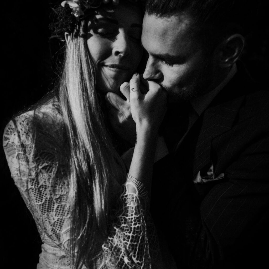 portrait of a couple kissing their hands